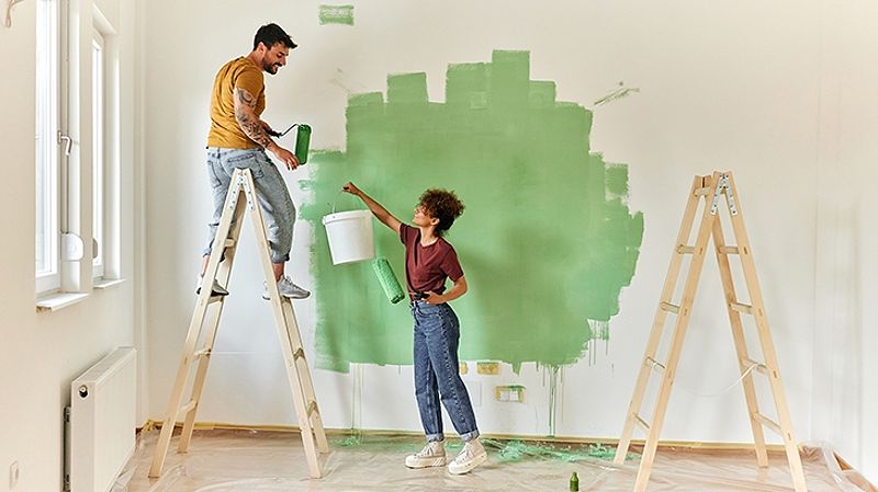 Couple painting their walls during a home renovation