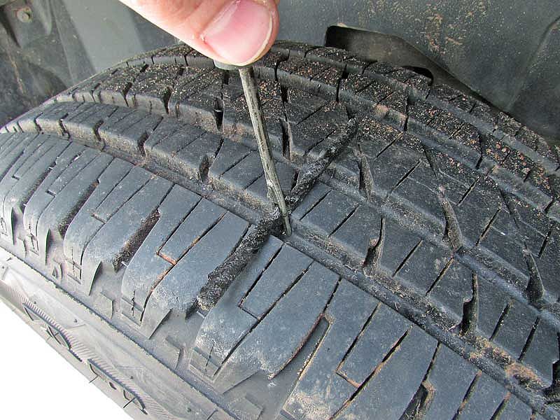 Push the tire plug into the hole. Don't twist the plug as you push it in, just go straight down and stop when there is about a 1/2-inch exposed.